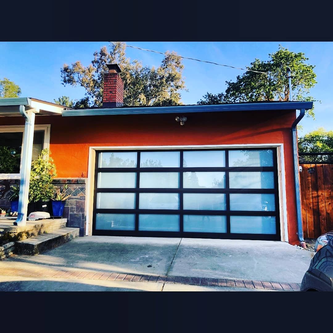 ModernFullViewGarageDoorBlackFrameWhiteWindows