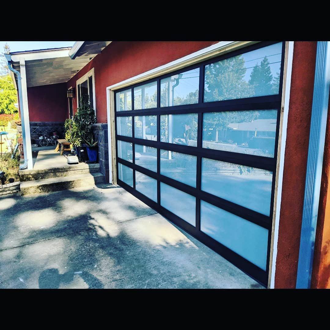 ModernFullViewGarageDoorBlackFrameWhiteWindowsSide