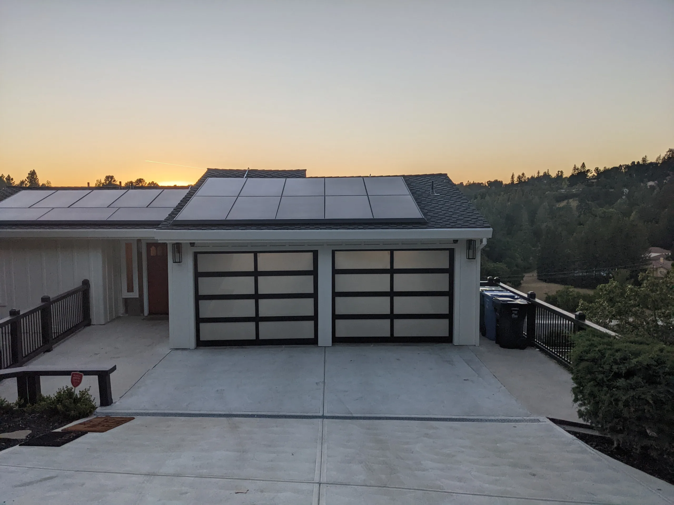 SingleCarFullViewGarageDoorsonHouseatSunset